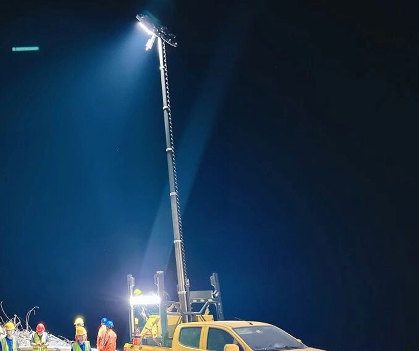 Mobile light tower lighting a night-time emergency work site