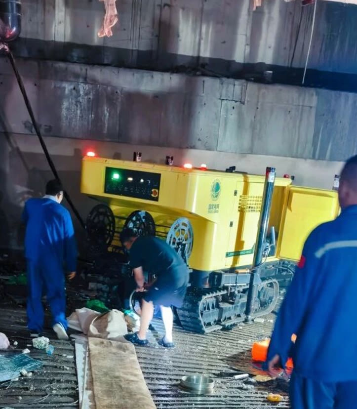 Drainage crew working alongside the tracked machine on site